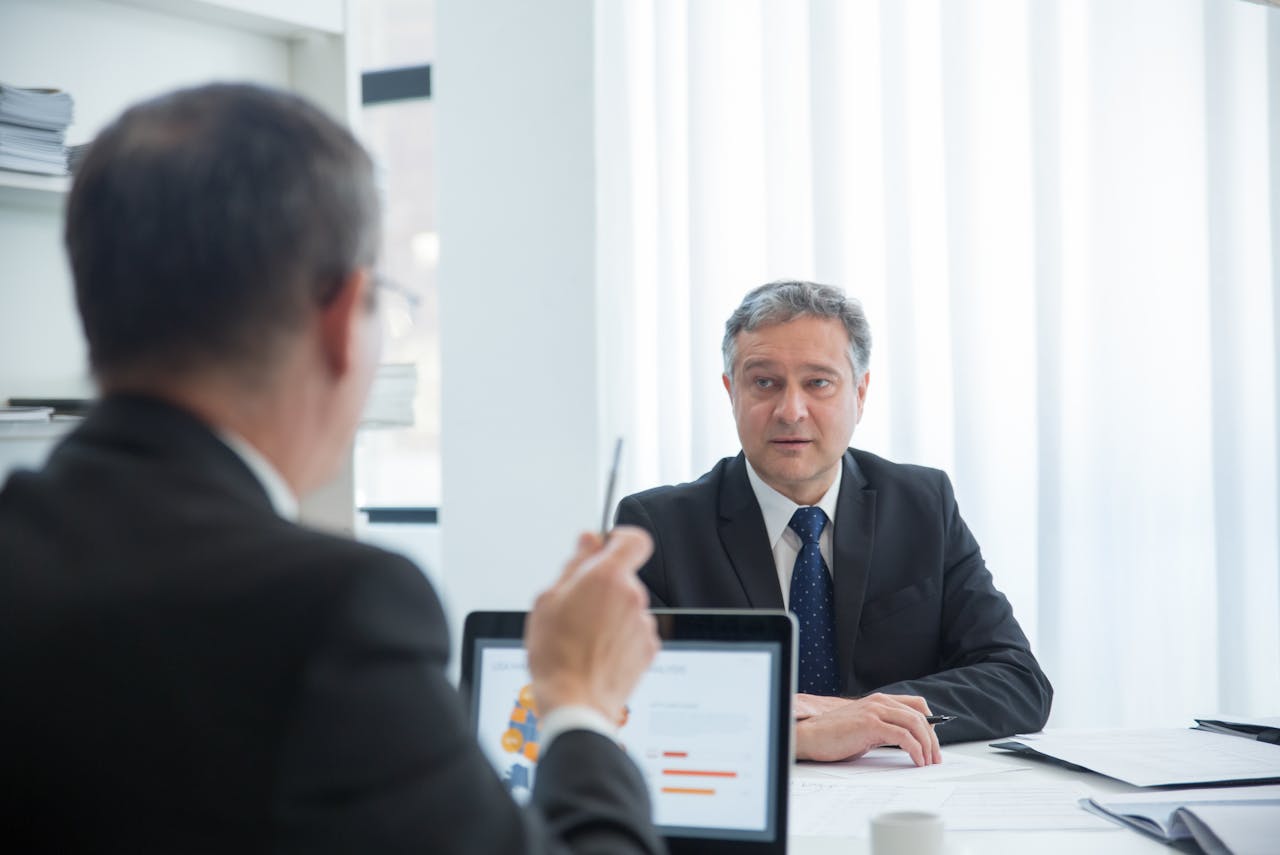 Business professionals in a focused discussion during an office meeting.